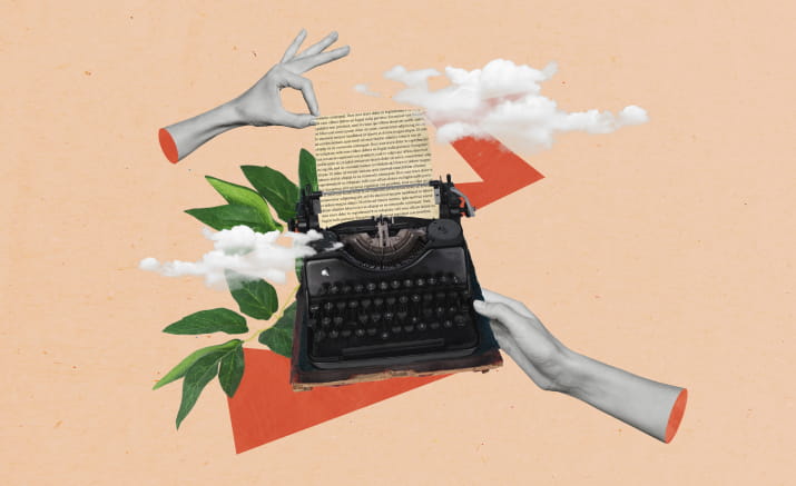 Disembodied hands pulling paper out of a typewriter