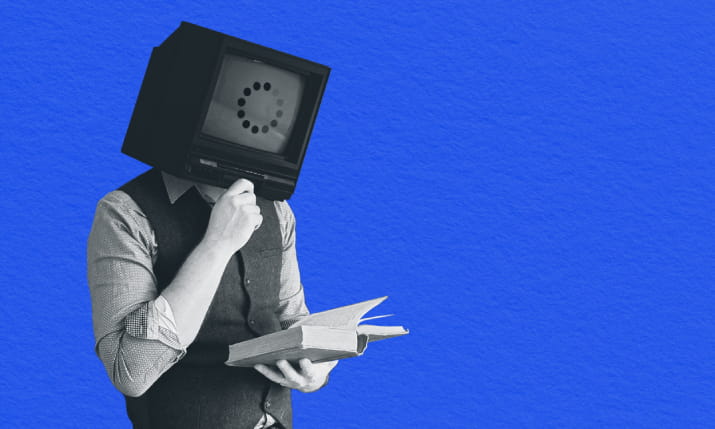 A man with a computer monitor for a face reading a book and learning