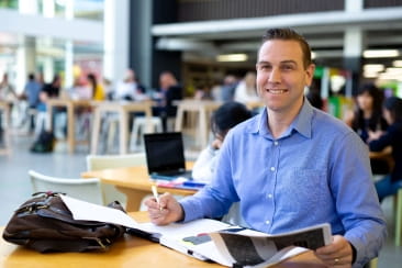 Open Universities Australia student David wearing professional clothes in a business setting.