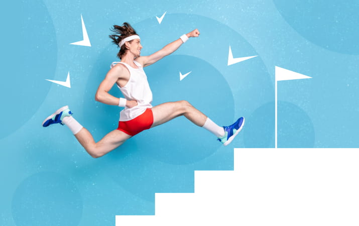A man in aerobic gear leaping up the stairs towards a flag