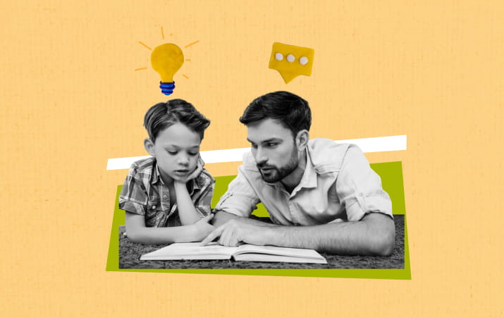 A son and father reading a book together 