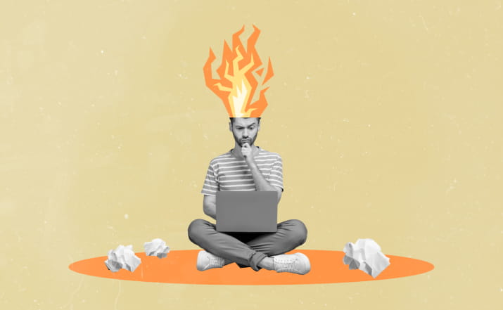 A confused man on a laptop with cartoon flames coming out of his head
